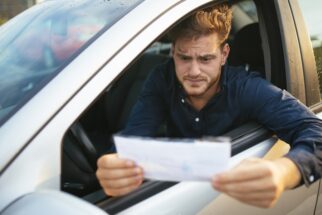 man receiving ticket from police